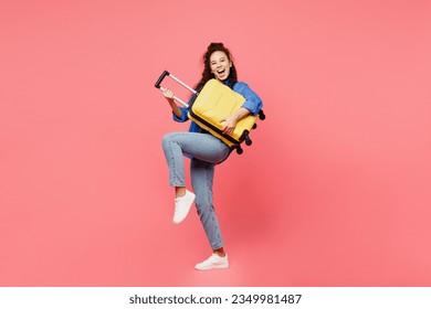 Traveler woman wears blue shirt casual clothes hold suitcase pov play guitar isolated on plain pink background. Tourist travel abroad in free spare time rest getaway. Air flight trip journey concept - Shutterstock ID 2349981487