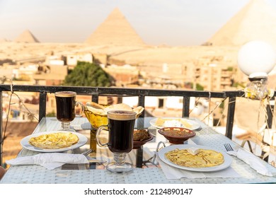 Traveler's breakfast. A table in an outdoor restaurant with a fantastically beautiful view of the great pyramids of Giza. Cairo. Egypt. Romantic dinner on the roof with a beautiful view.