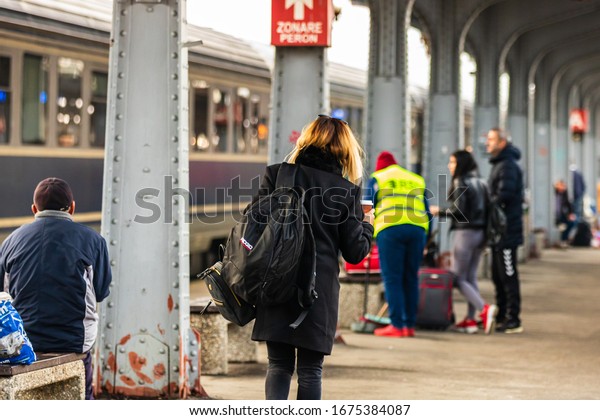 Travelers and commuters carry\
luggage and backpacks on the train platform of Bucharest North\
Railway Station (Gara de Nord Bucharest) in Bucharest, Romania,\
2020