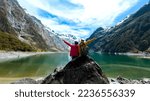  Travelers couple team look on the mountain landscape. Travel and active life concept  as Adventure travel in the mountains region in lake marian  fiordland national park