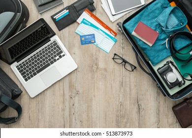 Traveler's Desktop With Laptop, Luggage, Credit Card And Airline Tickets, Travel And Vacations Concept, Flat Lay