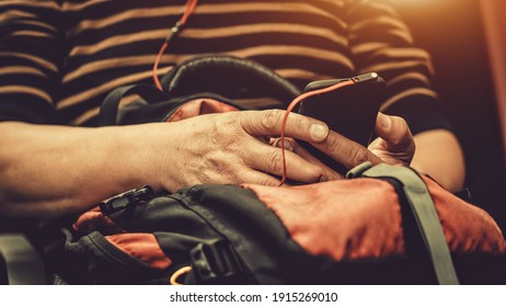 Travelers Living Smartphones Waiting For Mass Transit System Waiting For The Plane To Go On Vacation On Weekend, Select Focus And Film Tone With Light Fair