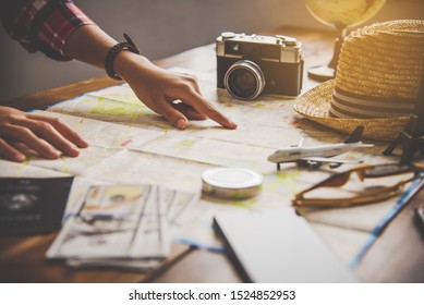 Travelers are planning a trip by searching the route on the map and searching for information on the internet. - Powered by Shutterstock