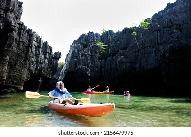 Travelers thai women paddle canoe boat of trip tour in sea ocean travel visit Ko Khao Yai and Prasat Hin Pan Yod in Mu Ko Petra National Park at Pak Bara in La ngu on April 12, 2022 in Satun, Thailand