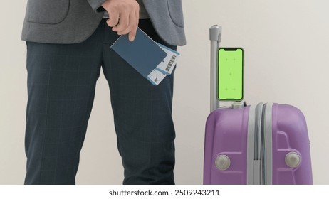 Traveling business man tourist with suitcase and smartphone chroma key green screen in international airport isolated on white background. Travel concept. - Powered by Shutterstock