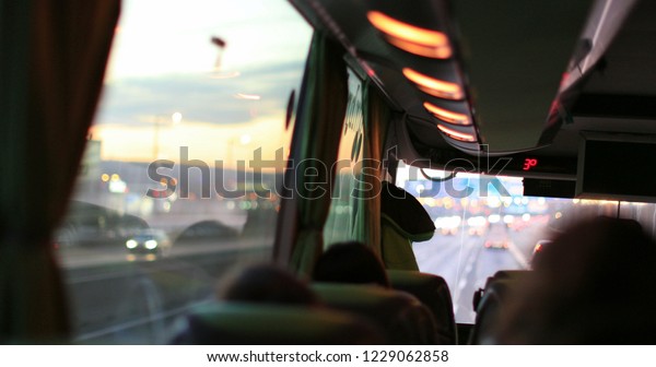 Traveling by bus. Passenger perspective POV from the\
back of the bus