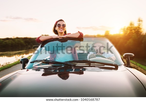 Traveling by car - couplr in love dgo by cabriolet\
car in sunset time