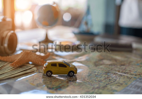 traveling concept accessories passport,
money, starfish,camera,boat, and map on wooden
board