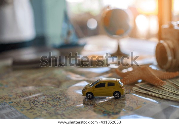 traveling concept accessories passport,\
money, starfish,camera,boat, and map on wooden\
board