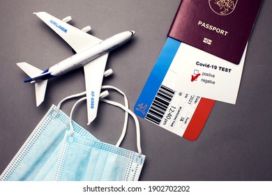 Traveling During COVID-19 Pandemic, Passport With Airline Ticket, Covid-19 Negative Test, Medical Masks And Plane On Grey Background, Airport Security Health And Safety Check Concept