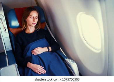 Traveling At First Class. Flight With Comfort. Pretty Young  Woman Sleeping In Airplane.