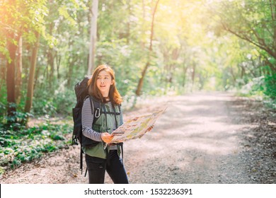 Traveling Happy Asian woman with backpack walking on path the tropical forest looking at the camera and map in green rainforests. Summer holiday and vacation trip , Survival travel, lifestyle concept  - Powered by Shutterstock