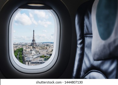 Traveling Paris, France famous landmark and travel destination in Europe. Aerial view Eiffel Tower through airplane window