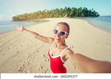 Traveling In Philippines. Pretty Young Woman In Red Swimsuit Taking Selfie On The White Sand Tropical Beach.