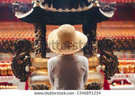 traveling woman burn incense and pray in Wenwu temple, Taiwan