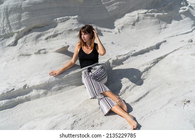 Traveling Woman Posing  Over White Stone Landscape On Delkikli Koy In  Aegean Sea. 