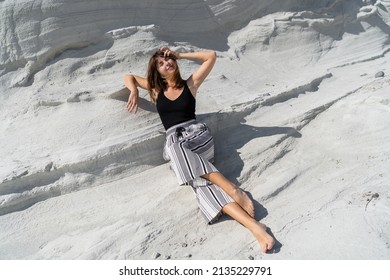 Traveling Woman Posing  Over White Stone Landscape On Delkikli Koy In  Aegean Sea. 