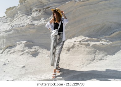 Traveling Woman In Straw Hat Posing  Over White Stone Landscape On Delkikli Koy In  Aegean Sea.  Full Lenght.