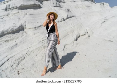 Traveling Woman In Straw Hat Posing  Over White Stone Landscape On Delkikli Koy In  Aegean Sea.  Full Lenght.