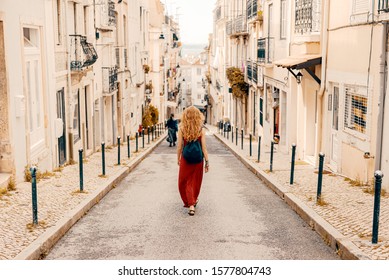 Traveller wearing a bag and white shirt exploring beautiful cityscape of Iberic country in Europe during summer sunset - Powered by Shutterstock