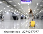 traveller woman walking at Krung Thep Aphiwat Central Terminal or Bang Sue Central station is the central passenger terminal in Bangkok and the current railway hub of Thailand with travel bag