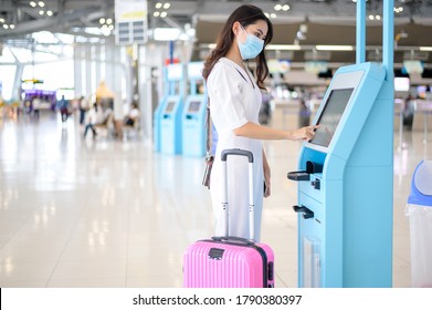 A Traveller Woman Is Wearing Protective Mask In International Airport, Travel Under Covid-19 Pandemic, Safety Travels, Social Distancing Protocol, New Normal Travel Concept .