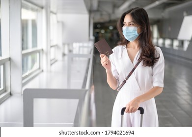 A Traveller Woman Is Wearing Protective Mask In International Airport, Travel Under Covid-19 Pandemic, Safety Travels, Social Distancing Protocol, New Normal Travel Concept .