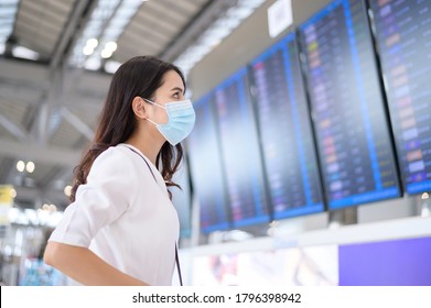 A Traveller Woman Is Wearing Protective Mask In International Airport, Travel Under Covid-19 Pandemic, Safety Travels, Social Distancing Protocol, New Normal Travel Concept .