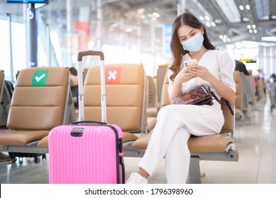 A Traveller Woman Is Wearing Protective Mask In International Airport, Travel Under Covid-19 Pandemic, Safety Travels, Social Distancing Protocol, New Normal Travel Concept .