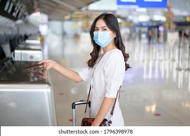 A Traveller Woman Is Wearing Protective Mask In International Airport, Travel Under Covid-19 Pandemic, Safety Travels, Social Distancing Protocol, New Normal Travel Concept .