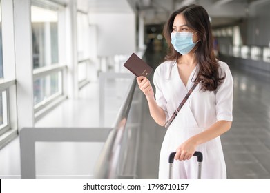 A Traveller Woman Is Wearing Protective Mask In International Airport, Travel Under Covid-19 Pandemic, Safety Travels, Social Distancing Protocol, New Normal Travel Concept .