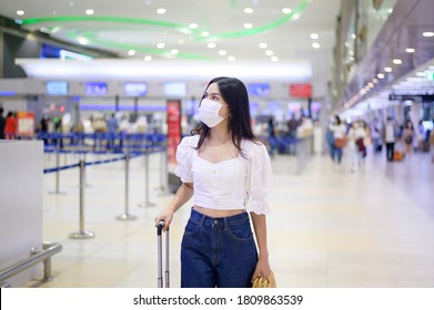 A Traveller Woman Is Wearing Protective Mask In International Airport, Travel Under Covid-19 Pandemic, Safety Travels, Social Distancing Protocol, New Normal Travel Concept