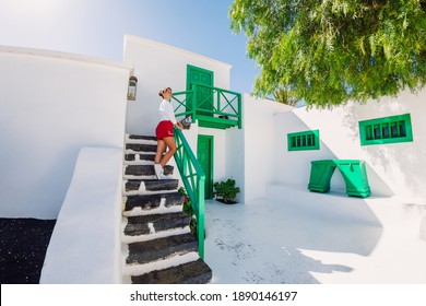 Traveller Young Woman Posing With The Historic Architecture In Lanzarote