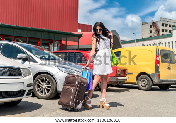 Travelling\
conception, woman with suitcase and\
car