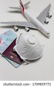 Travelling during corona virus epidemic. Passport and protective face mask respirator. Coronavirus and travel concept. Travelling with face mask. Corona virus prevention. Flights cancelled. Stay Home. - Shutterstock ID 1709859772