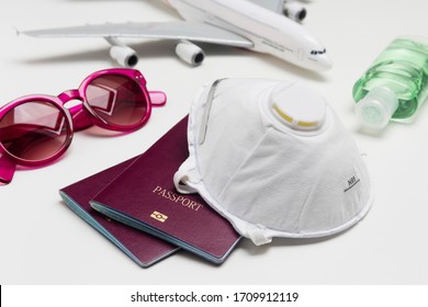 Travelling during the coronavirus outbreak. Passport with face mask, sunglasses and hand sanitizer gel. Travel and Holiday concept corona virus epidemic.  - Shutterstock ID 1709912119