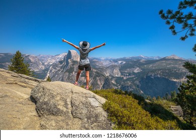 Travelling Enthusiast Woman Happy For The Glacier Point Aerial View In Yosemite National Park, California, US. Glacier Point Panorama: Half Dome, Liberty Cap, Yosemite Valley, Vernal Fall, Nevada Fall