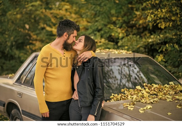 travelling and fall holiday. Love\
relationship and romance. Man and woman at car. Couple in love in\
autumn park. Autumn happy couple of girl and man\
outdoor.