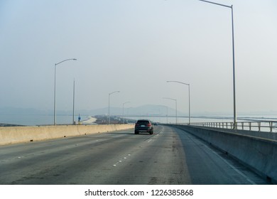 Travelling On Dumbarton Bridge Towards East San Francisco Bay Area; Smoke And Pollution In The Air From Nearby Wildfires; Silicon Valley, California