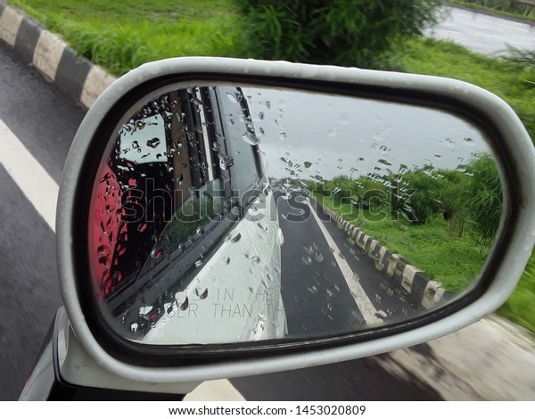 travelling on the highway  in car rear view through 
mirror 