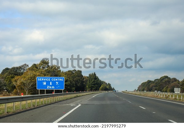 travelling on highway with rest stop service centre\
sign ahead