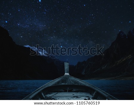 Travelling on lake at night by boat, sky full of star and milky way