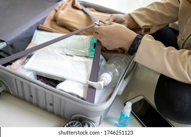 Travel,summer Vacation,new Normal,hands Of Asian Woman Preparing The Luggage,medical Face Mask,hand Sanitizer Gel In Suitcase For Protect,new Normal Life After Coronavirus Quarantine,Covid-19 Lockdown