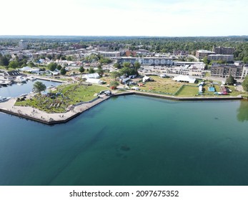 Traverse City Michigan and the shoreline of Grand Traverse Bay were captured from the air on an early July morning.  You can see Clinch Park Marina and the Open Space as well as portions of downtown. - Shutterstock ID 2097675352