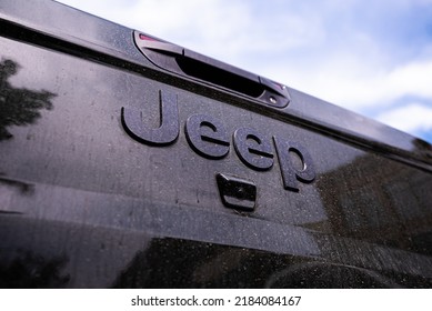 Traverse City, Michigan, USA - July 20 2022: Dirt, Mud, And Dust On Black Metal Back Trunk Truck Bed Hatch Door Of Jeep Wrangler.