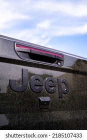 Traverse City, Michigan, USA - July 20 2022: Dirt, Mud, And Dust On Black Metal Back Trunk Truck Bed Hatch Door Of Jeep Wrangler.