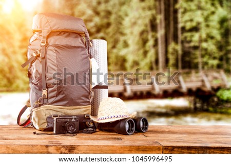 Travle backpack and river with forest 