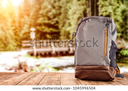 Travle backpack and river with forest 
