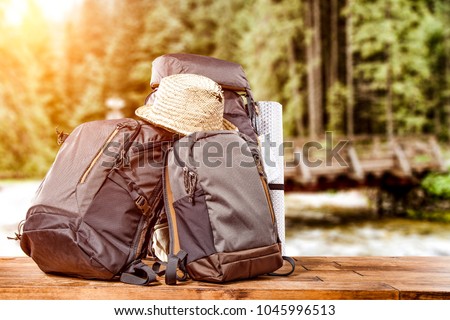 Travle backpack and river with forest 