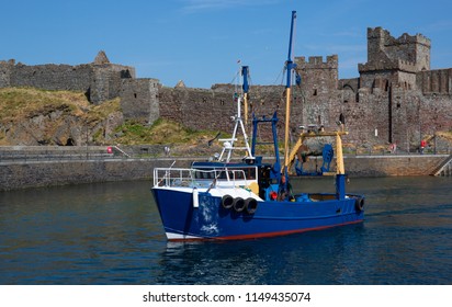 Trawler Boat In Harbour With  Peel Castle In The Background, Isle Of Man, British Isles